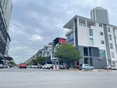 a street with cars parked in front of a building at Cozy Murni 14th Entire 3 Bedroom House at Alma Bkt Mertajam in Bukit Mertajam