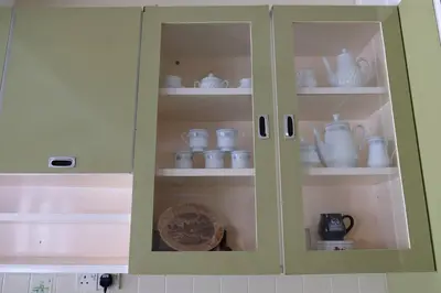 a cabinet with cups and dishes in it at Simple Home Taiping \u7b80\u5c45 Lakeview in Taiping