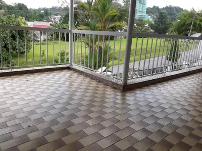 a balcony with a white fence and palm trees at Simple Home Taiping \u7b80\u5c45 Lakeview in Taiping