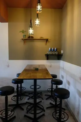 a table with stools in a room with a bar at Simple Home Taiping \u7b80\u5c45 Lakeview in Taiping