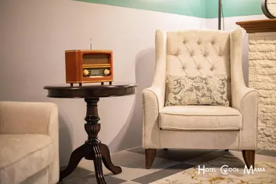 a chair and a table with a radio on it at Hotel COOL MAMA in Brinchang