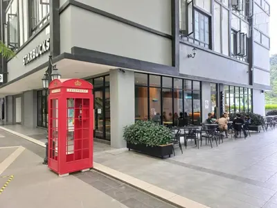 a red phone booth in front of a building at Hotel COOL MAMA in Brinchang