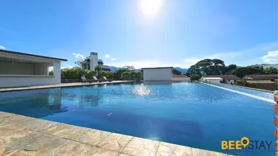 a swimming pool with blue water in a building at Kinta River Front Suites Ipoh by Beestay in Ipoh