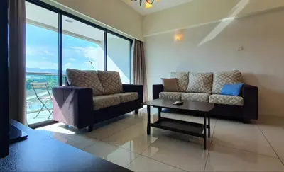 a living room with a couch and a table at Kinta River Front Suites Ipoh by Beestay in Ipoh