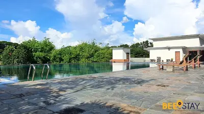 a swimming pool with a bench next to a house at Kinta River Front Suites Ipoh by Beestay in Ipoh