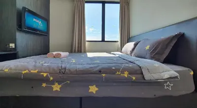 a bedroom with a bed with stars on it at Kinta River Front Suites Ipoh by Beestay in Ipoh