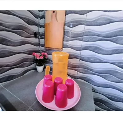 a plate with a group of pink candles on a table at HomeStay with Serene Surrounding in Nibung Tebal