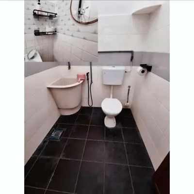 a bathroom with a toilet and a tub and a sink at HomeStay with Serene Surrounding in Nibung Tebal