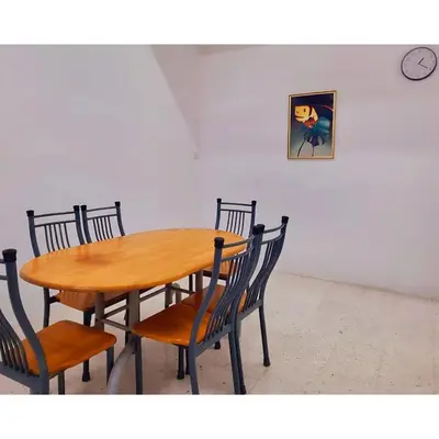 a wooden table and chairs in a room at HomeStay with Serene Surrounding in Nibung Tebal