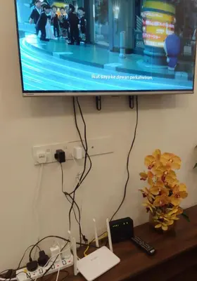 a flat screen tv sitting on top of a table at HOMESTAY IMPIAN, BATU GAJAH PERAK in Kampong Paya Rengas