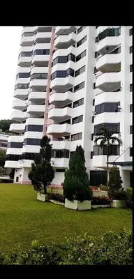 a large white building with trees in front of it at Seri Sayang Seaview Resort Batu Ferringhi in Batu Ferringhi