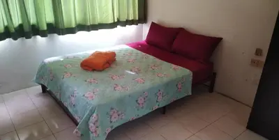 a bed in a room with a pillow on it at Seri Sayang Seaview Resort Batu Ferringhi in Batu Ferringhi
