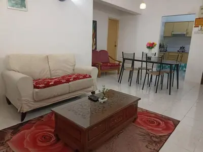a living room with a couch and a table at Seri Sayang Seaview Resort Batu Ferringhi in Batu Ferringhi