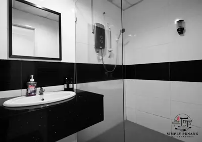 a black and white bathroom with a sink and a shower at Mansion One by Simply Penang in George Town