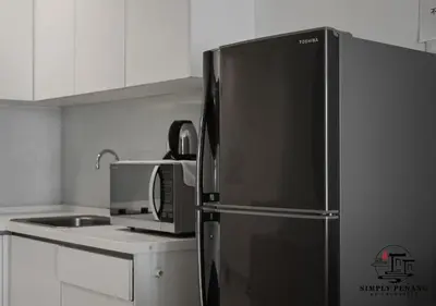 a kitchen with a stainless steel refrigerator and a sink at Mansion One by Simply Penang in George Town