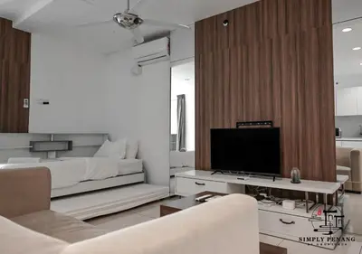 a living room with a bed and a television at Mansion One by Simply Penang in George Town