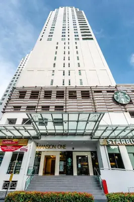 a tall white building with a clock on it at Mansion One by Simply Penang in George Town