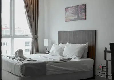 a bed with a stuffed animal sitting on top of it at Mansion One by Simply Penang in George Town