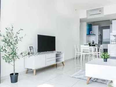a white living room with a tv on a cabinet at BEACON LeNa #Seaview#RoofTopPool#6pax#Georgetown in George Town