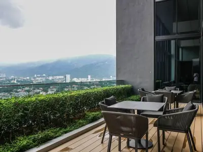 a restaurant with tables and chairs on a balcony at BEACON LeNa #Seaview#RoofTopPool#6pax#Georgetown in George Town