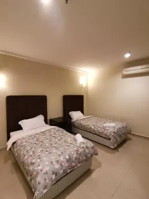 a room with two beds in a room at Spacious & Homey Apartment at Marina Island by JoMy Homestay in Lumut