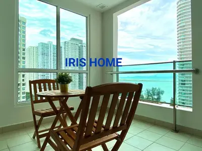 a table and two chairs in a room with windows at Mansion One Seaview Luxury 2 Bedroom Gurney Georgetown gleneagles in George Town