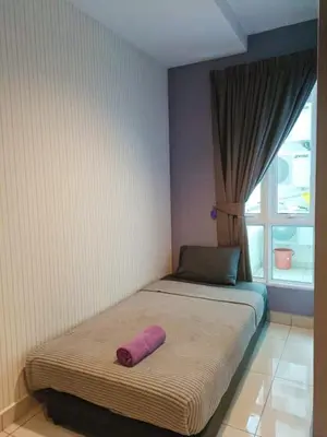 a bedroom with a bed with a pink pillow on it at Mansion One Seaview Luxury 2 Bedroom Gurney Georgetown gleneagles in George Town