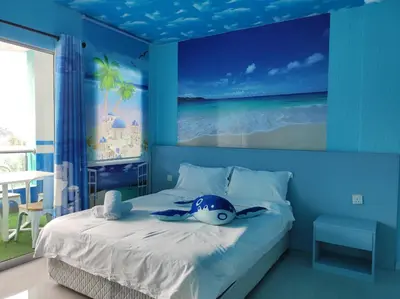a bedroom with a bed with a blue wall at Marina Island Ocean Theme @ Lumut Sitiawan in Lumut