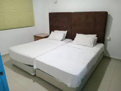 two beds sitting next to each other in a room at Marina Island Ocean Theme @ Lumut Sitiawan in Lumut