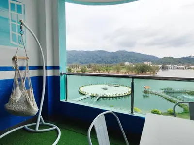 a room with a balcony with a view of a fountain at Marina Island Ocean Theme @ Lumut Sitiawan in Lumut