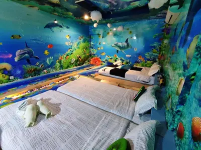 a bedroom with an underwater room with two beds at Marina Island Ocean Theme @ Lumut Sitiawan in Lumut