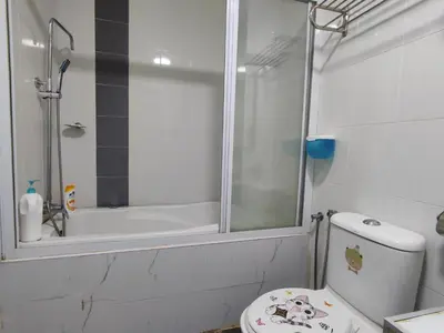a white bathroom with a shower and a toilet at Marina Island Ocean Theme @ Lumut Sitiawan in Lumut