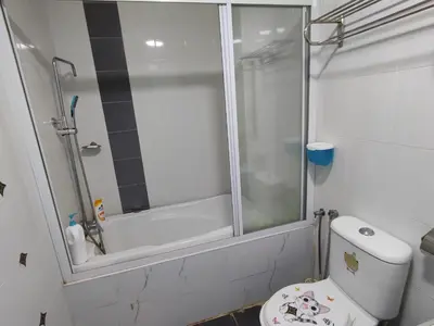 a bathroom with a shower and a white toilet at Marina Island Ocean Theme @ Lumut Sitiawan in Lumut