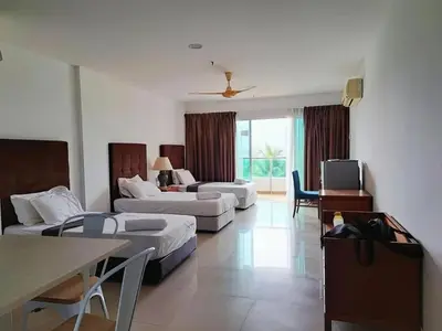 a large living room with two beds and a table at Marina Island Ocean Theme @ Lumut Sitiawan in Lumut