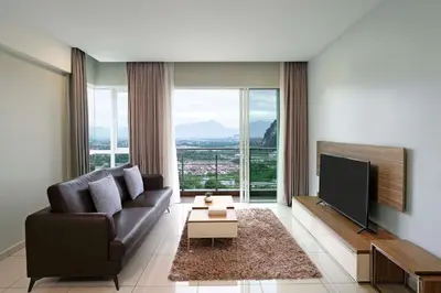 a living room with a couch and a flat screen tv at TUI BLUE The Haven Ipoh in Ipoh