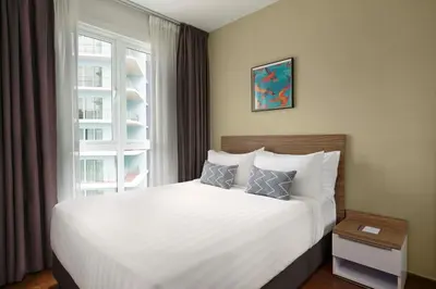 a bedroom with a white bed and a window at TUI BLUE The Haven Ipoh in Ipoh