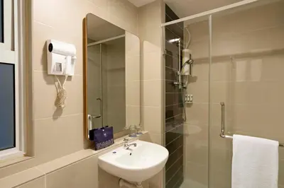 a bathroom with a sink and a shower at TUI BLUE The Haven Ipoh in Ipoh
