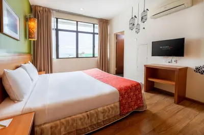 a hotel room with a bed and a television at Victoria Inn, Penang in George Town