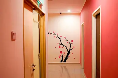 a hallway with a tree stenciled on the wall at Victoria Inn, Penang in George Town