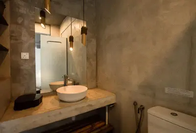 a bathroom with a sink and a mirror and a toilet at Amazing Home Inn in George Town