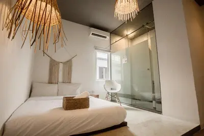 a bedroom with a bed and two chandeliers at Amazing Home Inn in George Town