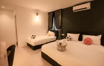 a hotel room with two beds with soccer balls on them at Amazing Home Inn in George Town