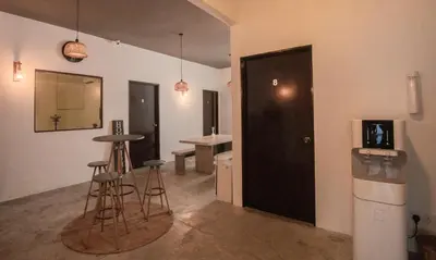 a room with bar stools and a door with a table at Amazing Home Inn in George Town