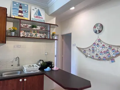 a kitchen with a counter top and a sink at EE's Summer House - Homestay 3 min walk to beach in Batu Ferringhi