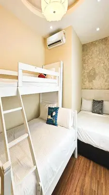 a room with two bunk beds and a couch at Pearl Rice Garden (European Style) in Sekincan