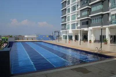 a large swimming pool in front of a building at Pearl Rice Garden (European Style) in Sekincan