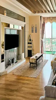 a living room with a fireplace and a tv at Pearl Rice Garden (European Style) in Sekincan