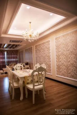 a dining room with a table and chairs and a chandelier at Pearl Rice Garden (European Style) in Sekincan