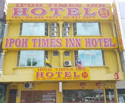 a yellow building with a sign for a hotel at Ipoh Times Inn Hotel in Ipoh