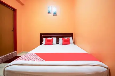 a bedroom with a large bed with red pillows at Ipoh Times Inn Hotel in Ipoh